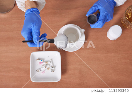 The hand of a CSI Scientific Investigation Unit researcher who is checking evidence and collecting fingerprints at crime and incident sites 115393340