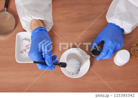 The hand of a CSI Scientific Investigation Unit researcher who is checking evidence and collecting fingerprints at crime and incident sites The hand of a CSI Scientific Investigation Unit researcher who is checking evidence and collecting fingerprints at crime and incident sites 115393342