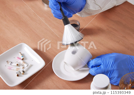 The hand of a CSI Scientific Investigation Unit researcher who is checking evidence and collecting fingerprints at crime and incident sites The hand of a CSI Scientific Investigation Unit researcher who is checking evidence and collecting fingerprints at crime and incident sites 115393349