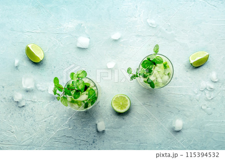 Mojito cocktail. Summer cold drink with lime, fresh mint, and ice. Cool beverage Mojito cocktail. Summer cold drink with lime, fresh mint, and ice. Cool beverage 115394532