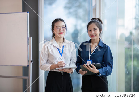 Professional Business Team Meeting Colleagues in Modern Office Setting with Digital Devices and Whiteboard for Collaborative Work 115395824