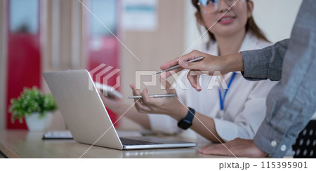 Business Team Analyze Data and Discuss strategy in a Modern Office Setting with Laptop and Documents 115395901