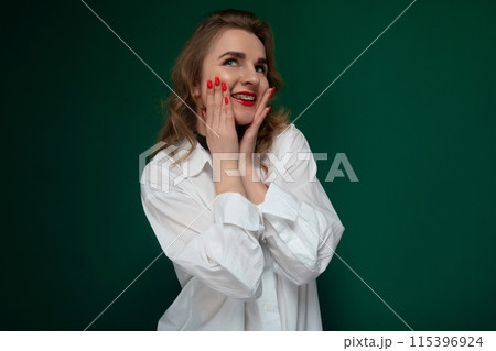 Woman in White Shirt Holding Hands to Face Woman in White Shirt Holding Hands to Face 115396924