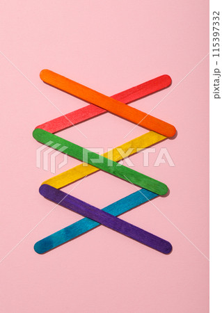 LGBT parade concept, holiday symbols on pink background. LGBT parade concept, holiday symbols on pink background. 115397332