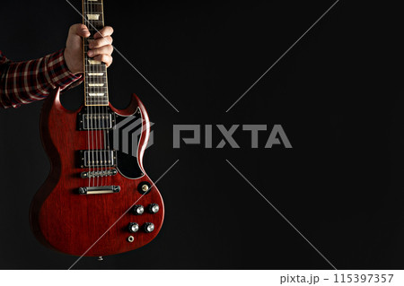 A man plays a beautiful guitar close-up A man plays a beautiful guitar close-up 115397357
