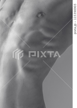 Monochrome image of male muscular body. Abstract Anatomy. Human natural muscular torso in landscape of shadows and light. 115398903