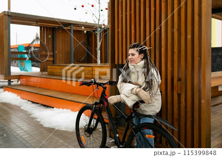 Woman With Dreadlocks Sitting on a Bike Woman With Dreadlocks Sitting on a Bike 115399848