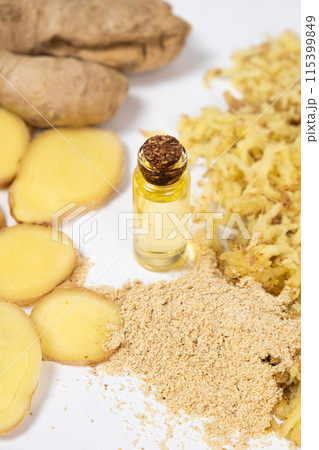 Natural ginger oil in glass bottle among ginger roots 115399849