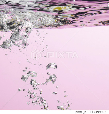 Different waves of air bubbles caused by falling water on a colorful background. Different waves of air bubbles caused by falling water on a colorful background. 115399906