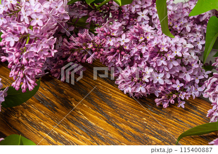 Beautiful spring flowers lilac on a wooden vintage board with place for text. Syringa vulgaris. Happy Mother's Day greetings card. Beautiful spring flowers lilac on a wooden vintage board with place for text. Syringa vulgaris. Happy Mother's Day greetings card. 115400887