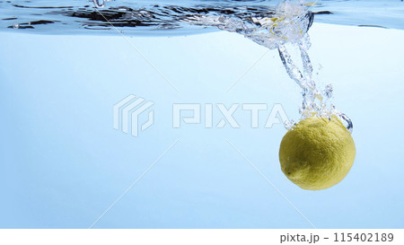 Fresh fruit falling into the water. Organic fruits for making effective juices for dieting. 115402189