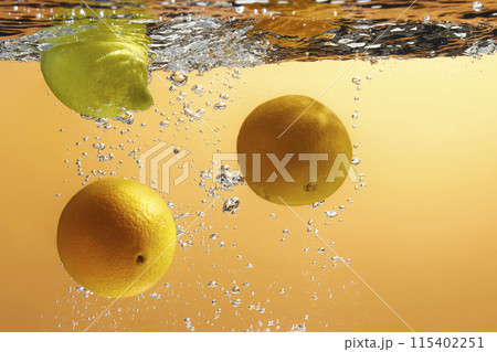 Fresh fruit falling into the water. Organic fruits for making effective juices for dieting. 115402251