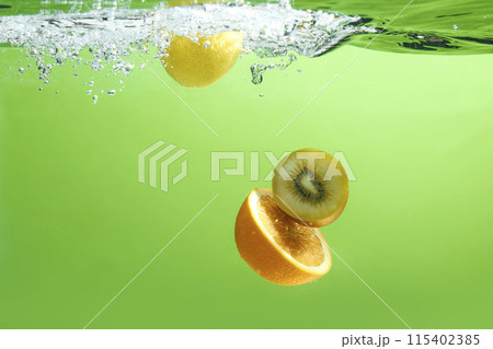Fresh fruit falling into the water. Organic fruits for making effective juices for dieting. Fresh fruit falling into the water. Organic fruits for making effective juices for dieting. 115402385