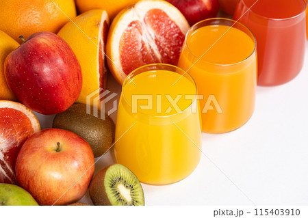 Different fruit juices in glasses on white background 115403910