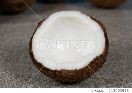 Half a coconut with coconut water inside, close-up of coconut flesh. Half a coconut with coconut water inside, close-up of coconut flesh. 115403938