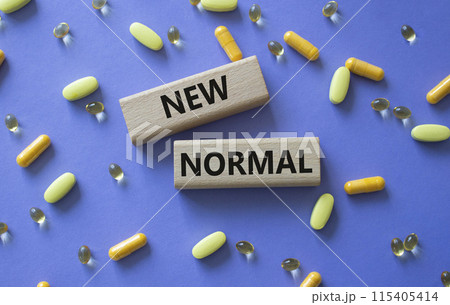 New normal symbol. Wooden blocks with words New normal. Beautiful purple background with pills. Medicine and New normal concept. Copy space. New normal symbol. Wooden blocks with words New normal. Beautiful purple background with pills. Medicine and New normal concept. Copy space. 115405414
