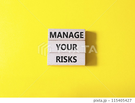 Manage your Risks symbol. Concept words Manage your Risks on wooden blocks. Beautiful yellow background. Business and Manage your Risks concept. Copy space. Manage your Risks symbol. Concept words Manage your Risks on wooden blocks. Beautiful yellow background. Business and Manage your Risks concept. Copy space. 115405427