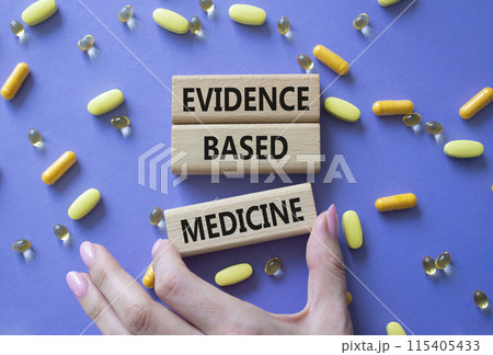 Evidence Based Medicine symbol. Concept word Evidence Based Medicine on wooden blocks. Doctor health. Beautiful purple background with pills. Medicine and Evidence Based Medicine concept. Copy space 115405433