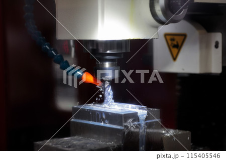 closeup of metal milling process using CNC machine 115405546