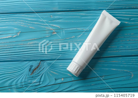 Toothpaste tube on a rustic blue wooden surface 115405719