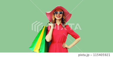 Portrait beautiful happy smiling young woman model posing with colorful shopping bags in summer hat 115405921