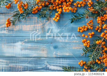 Buckthorn berries on a blue rustic wooden background 115406024