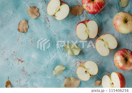 Whole and halved apples on a table, top view Whole and halved apples on a table, top view 115406256