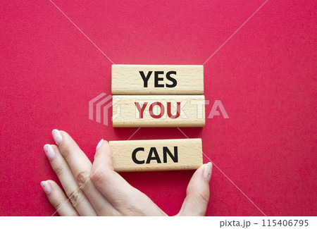 Yes You Can symbol. Concept word Yes You Can on wooden blocks. Beautiful blue background. Businessman hand. Business and Yes You Can concept. Copy space. 115406795