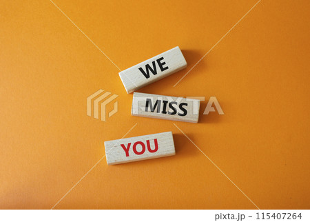 We Miss you symbol. Concept words We Miss you on wooden blocks. Beautiful orange background. Emotion and We Miss you concept. Copy space. 115407264