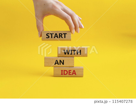Start with an Idea symbol. Wooden blocks with words Start with an Idea. Beautiful yellow background. Businessman hand. Business and Start with an Idea concept. Copy space. 115407278