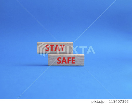 Stay Safe symbol. Concept word Stay Safe on wooden blocks. Beautiful blue background. Business and Stay Safe concept. Copy space 115407395