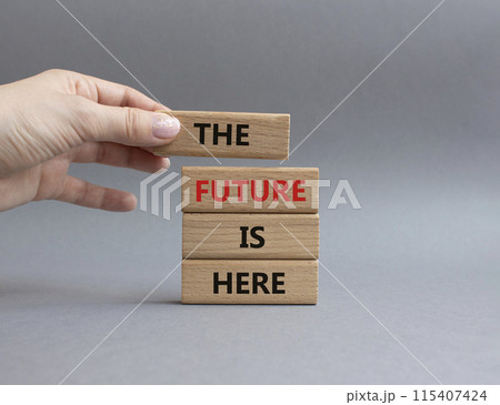 The future is here symbol. Concept words The future is here on wooden blocks. Beautiful grey background. Businessman hand. Business and The future is here concept. Copy space. The future is here symbol. Concept words The future is here on wooden blocks. Beautiful grey background. Businessman hand. Business and The future is here concept. Copy space. 115407424