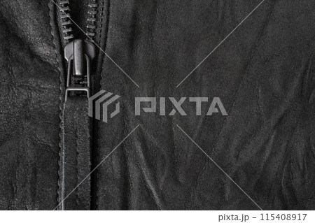Crumpled black suede textured horizontal background with black metal zip Crumpled black suede textured horizontal background with black metal zip 115408917