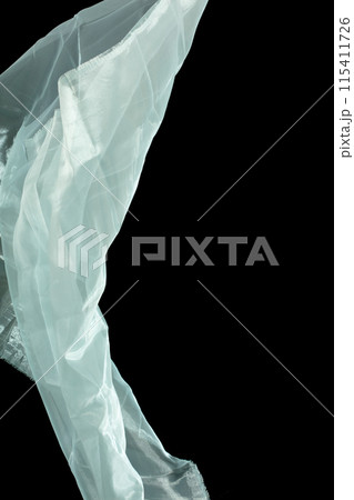 Off White Organza fabric flying in curve shape, Piece of textile White Organza fabric throw fall in air. Black background isolated motion blur Off White Organza fabric flying in curve shape, Piece of textile White Organza fabric throw fall in air. Black background isolated motion blur 115411726