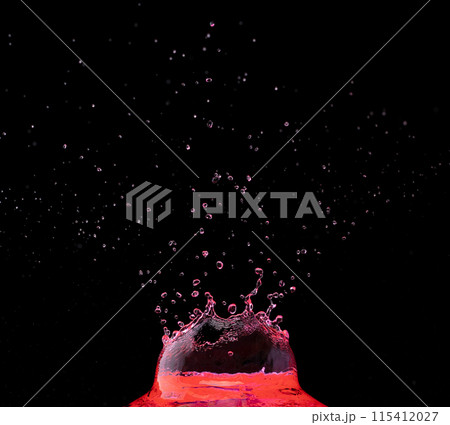 Red wine Crown Water splash on object to create shape form fluttering in droplet and wave. Cherry tomato juice Crown water to object make curve drop blood explosion. Black background isolated Red wine Crown Water splash on object to create shape form fluttering in droplet and wave. Cherry tomato juice Crown water to object make curve drop blood explosion. Black background isolated 115412027