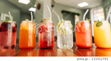 Fruit drinks with berries and ice in glass glasses and straws on a wooden table Fruit drinks with berries and ice in glass glasses and straws on a wooden table 115412791