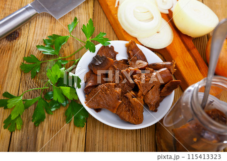 Chopped pickled mushrooms (Lactarius deliciosus) on board Chopped pickled mushrooms (Lactarius deliciosus) on board 115413323
