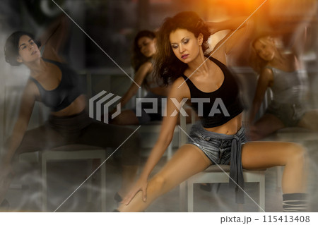 Stylized shot of young woman mastering lap dance on chair in studio Stylized shot of young woman mastering lap dance on chair in studio 115413408