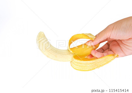 Half peeled ripe banana , ripe banana in a hand isolated on white background Half peeled ripe banana , ripe banana in a hand isolated on white background 115415414