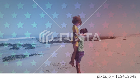 Young African American couple embraces on a star-patterned beach 115415648