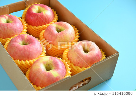 beautiful pink apple in the box on blue background 115416090