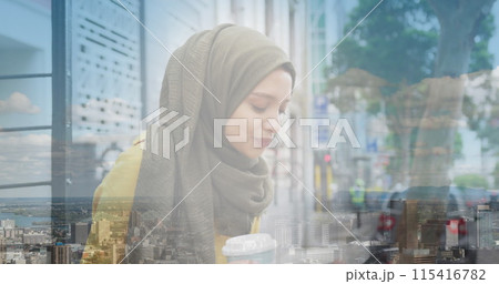 Image of asian woman in hijab drinking coffee over landscape 115416782