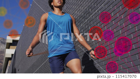 Image of media icons over african american man jumping rope Image of media icons over african american man jumping rope 115417070