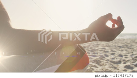 Image of lights over a meditating african american man 115417178