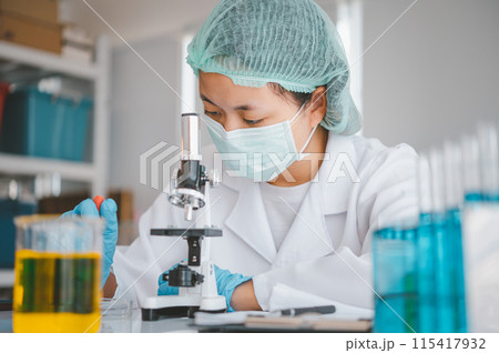 Female researchers are experimenting with pipette dropping a sample into a test tube in an experiment research in laboratory... Female researchers are experimenting with pipette dropping a sample into a test tube in an experiment research in laboratory... 115417932