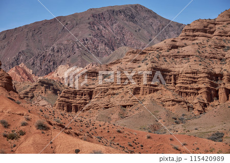 Kyrgyzstan nature, Konorchek Canyon valley. Red sandstone rocks, cliffs. Famous travel place, natural background  115420989