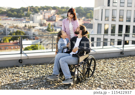 Mother and daughter support dad in treatment of serious injury. 115422937