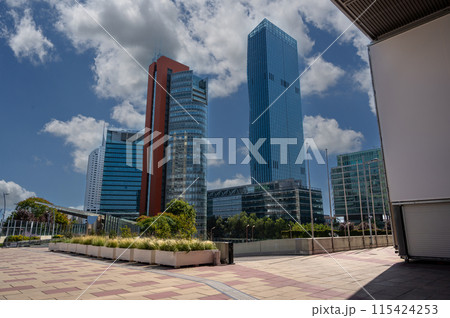 Vienna, Austria, August 17, 2022. Donau City, or Vienna DC is the city district characterized by modern skyscrapers. On the right the characteristic DC Tower 1. Beautiful sunny day. 115424253
