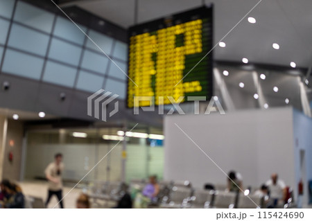 Blurred and defocused image of Airport Terminal. Arrival, Departure Information Display. People in airport terminal. Traveling concept. Departure lounge at the airport. 115424690