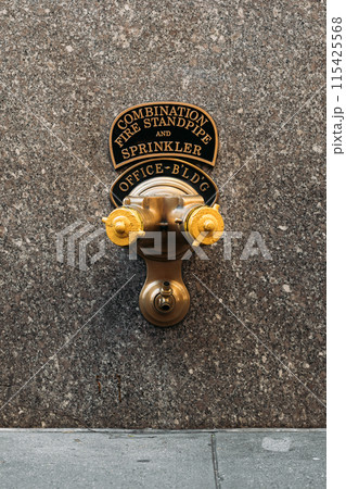 Combination fire standpipe and sprinkler system on an office building wall in New York Combination fire standpipe and sprinkler system on an office building wall in New York 115425568